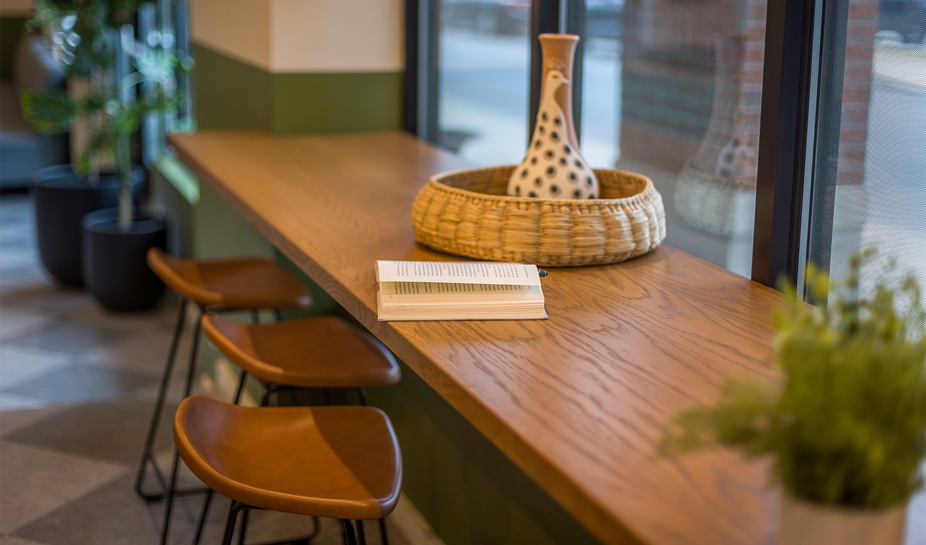 A boutique apartment community a book on a table with stools